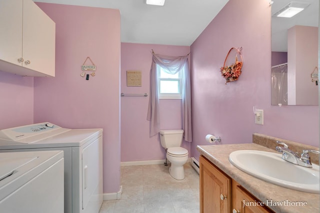 5777 N Broadway, Freeport, MI 49325 - bathroom with washer and clothes dryer, a baseboard heating unit, vanity, toilet, and baseboards