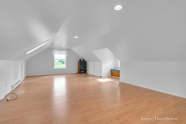 5777 N Broadway, Freeport, MI 49325 - bonus room featuring a baseboard radiator, light wood-style floors, vaulted ceiling, baseboards, and recessed lighting