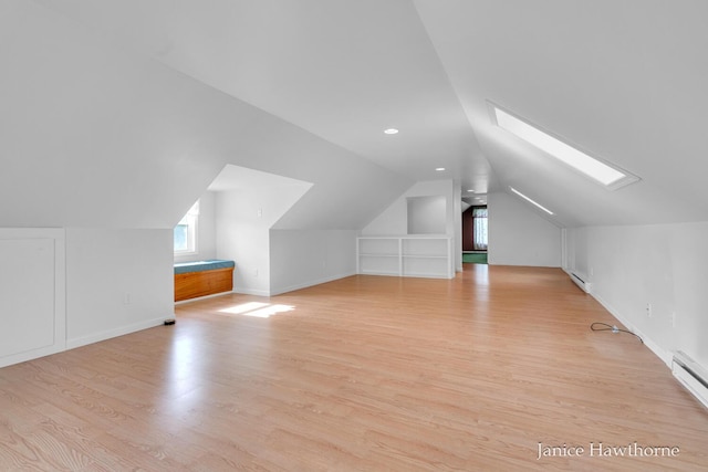 5777 N Broadway, Freeport, MI 49325 - bonus room with a skylight, vaulted ceiling, light wood finished floors, baseboard heating, and baseboards