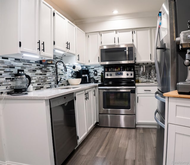 4241 Schaefer Rd, Dearborn, MI 48126 - kitchen with stainless steel appliances, a sink, light countertops, white cabinetry, and dark wood-style flooring