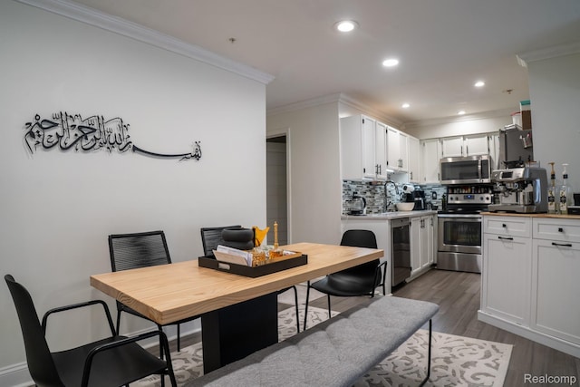4241 Schaefer Rd, Dearborn, MI 48126 - kitchen with appliances with stainless steel finishes, ornamental molding, backsplash, dark wood finished floors, and recessed lighting