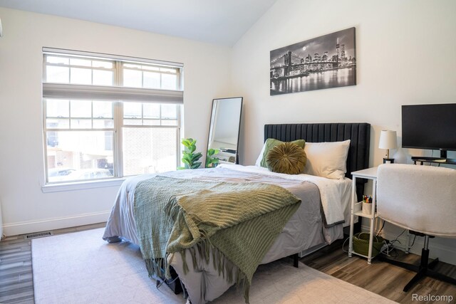 4241 Schaefer Rd, Dearborn, MI 48126 - bedroom featuring wood finished floors, vaulted ceiling, and baseboards