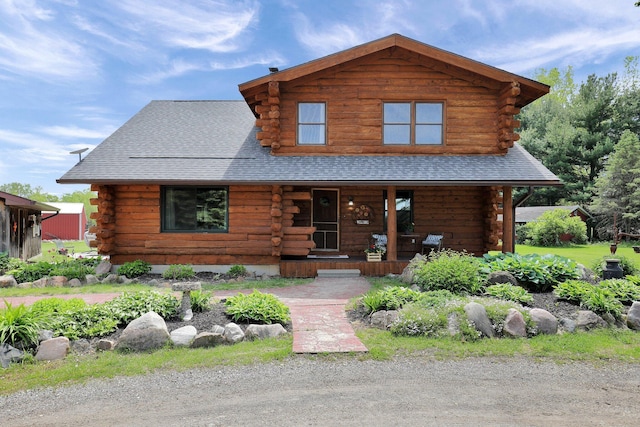 3457 S Keefer Hwy, Lyons, MI 48851 - log cabin with log siding, covered porch, and roof with shingles