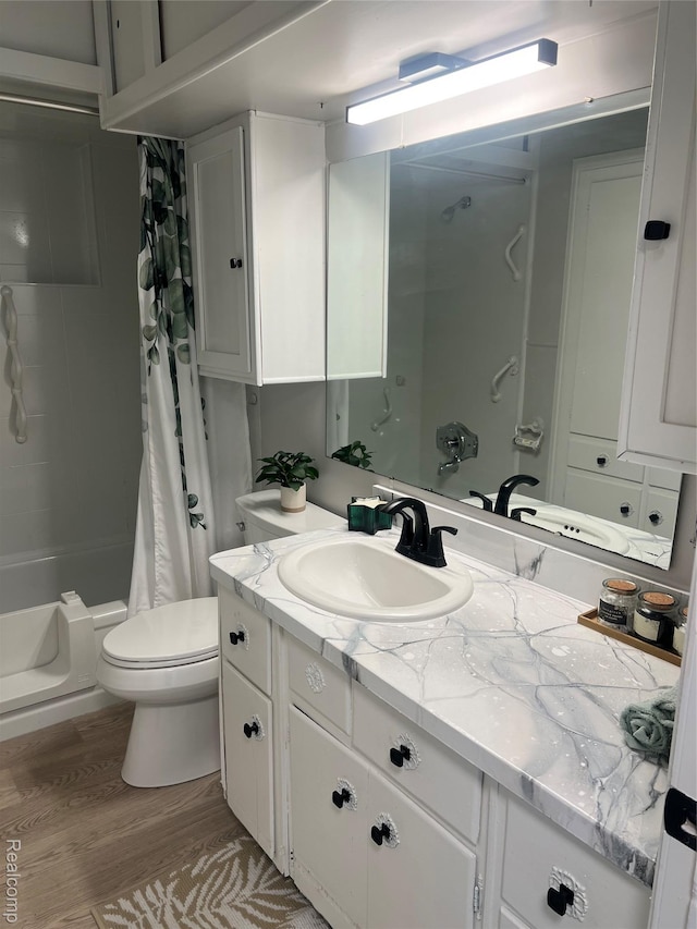 1932 Henbert Rd, West Bloomfield, MI 48324 - bathroom with vanity, shower / bath combo with shower curtain, toilet, and wood finished floors