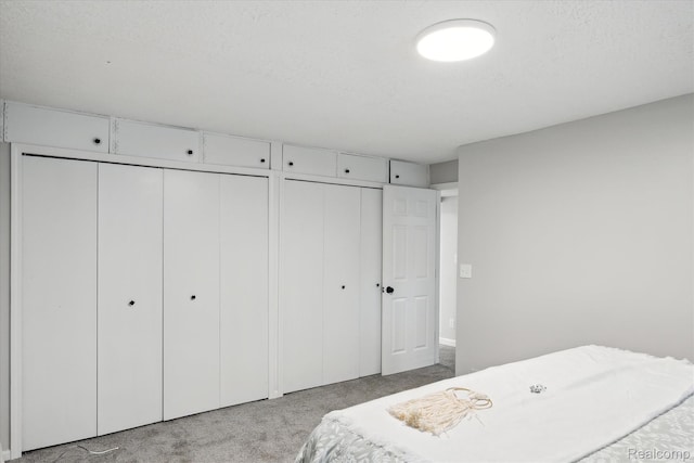 1932 Henbert Rd, West Bloomfield, MI 48324 - carpeted bedroom featuring two closets and a textured ceiling