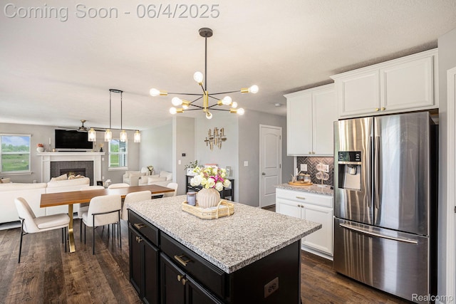 13210 River Bend Dr, Linden, MI 48451 - kitchen with stainless steel fridge with ice dispenser, open floor plan, dark wood-type flooring, a chandelier, and a center island