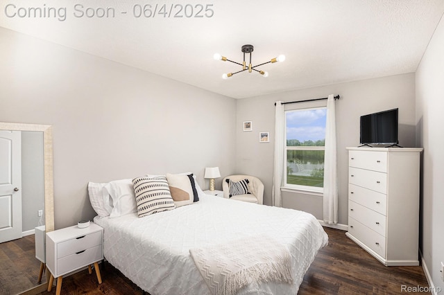 13210 River Bend Dr, Linden, MI 48451 - bedroom featuring a chandelier, dark wood-style floors, and baseboards