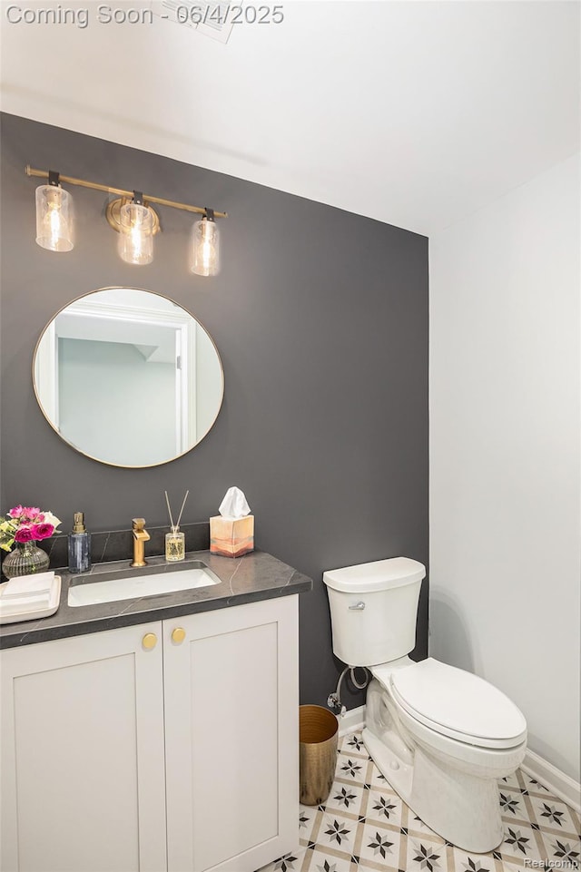 13210 River Bend Dr, Linden, MI 48451 - bathroom with toilet, vanity, and baseboards