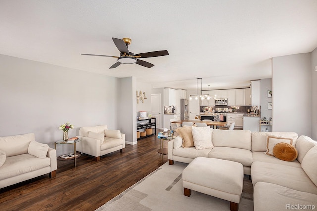 13210 River Bend Dr, Linden, MI 48451 - living room with wood finished floors, a ceiling fan, and a chandelier