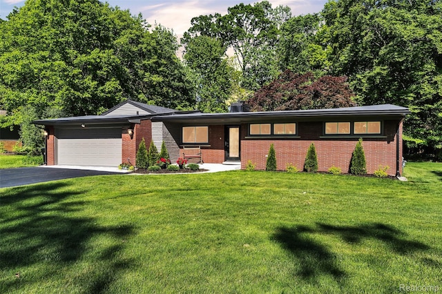28200 E Greenmeadow Cir, Farmington Hills, MI 48334 - view of front of property with an attached garage, brick siding, asphalt driveway, and a front yard