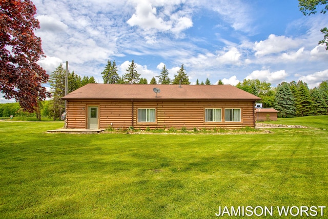 4403 4th St, Caledonia, MI 49316 - back of property featuring log siding, a yard, and roof with shingles
