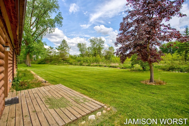 4403 4th St, Caledonia, MI 49316 - view of green lawn featuring a deck and view of scattered trees