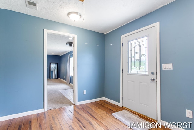 4403 4th St, Caledonia, MI 49316 - entryway featuring hardwood / wood-style flooring, baseboards, and a textured ceiling
