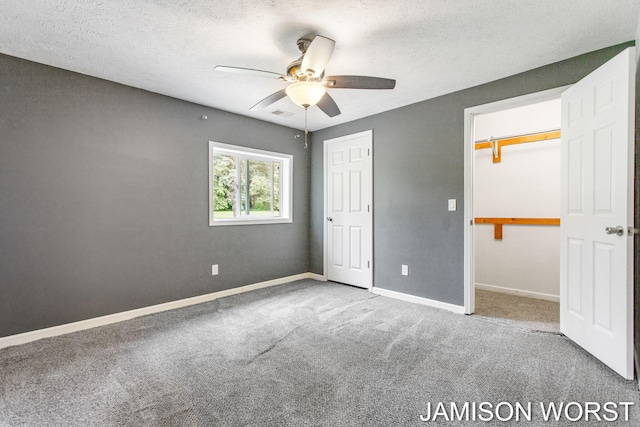 4403 4th St, Caledonia, MI 49316 - unfurnished bedroom featuring carpet floors, a textured ceiling, baseboards, a closet, and a ceiling fan