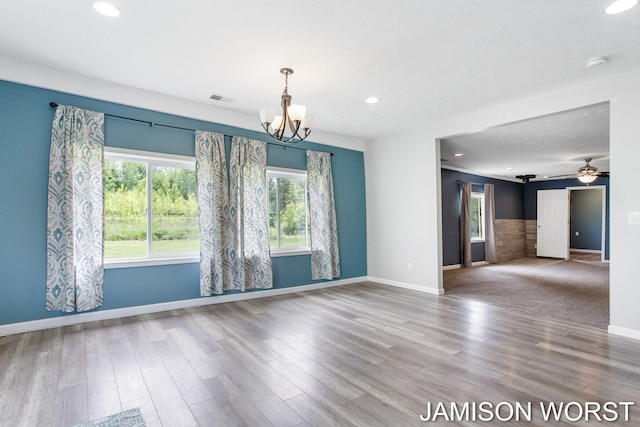 4403 4th St, Caledonia, MI 49316 - unfurnished room with recessed lighting, a chandelier, wood finished floors, and baseboards