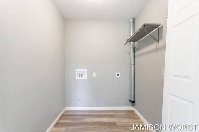 4403 4th St, Caledonia, MI 49316 - laundry area featuring washer hookup, light wood-type flooring, a textured ceiling, and baseboards