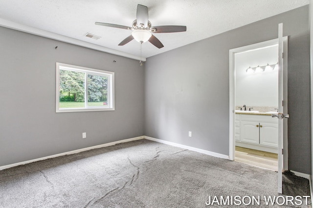 4403 4th St, Caledonia, MI 49316 - unfurnished bedroom with carpet flooring, baseboards, ensuite bath, and ceiling fan