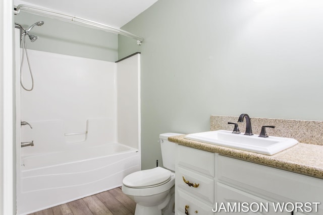4403 4th St, Caledonia, MI 49316 - full bath with vanity, toilet, shower / washtub combination, and wood finished floors