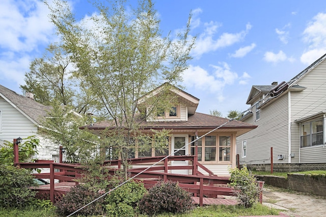 205 Corinne St SW, Grand Rapids, MI 49507 - back of property with a deck, a sunroom, and a shingled roof
