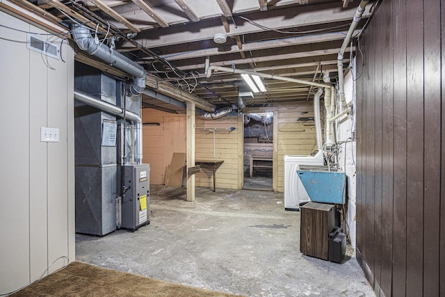 205 Corinne St SW, Grand Rapids, MI 49507 - unfinished below grade area featuring washer / dryer, wooden walls, and heating unit