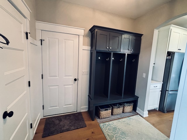 1692 Gloryfield Dr, Byron Center, MI 49315 - mudroom with arched walkways, baseboards, and wood finished floors