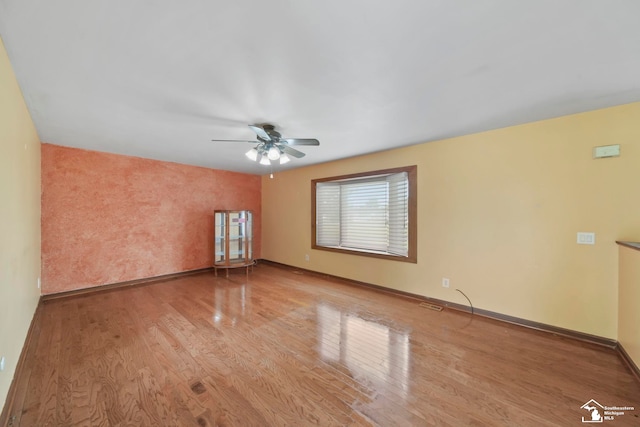 214 Roosevelt St, Dundee, MI 48131 - empty room with wood finished floors, a ceiling fan, and baseboards