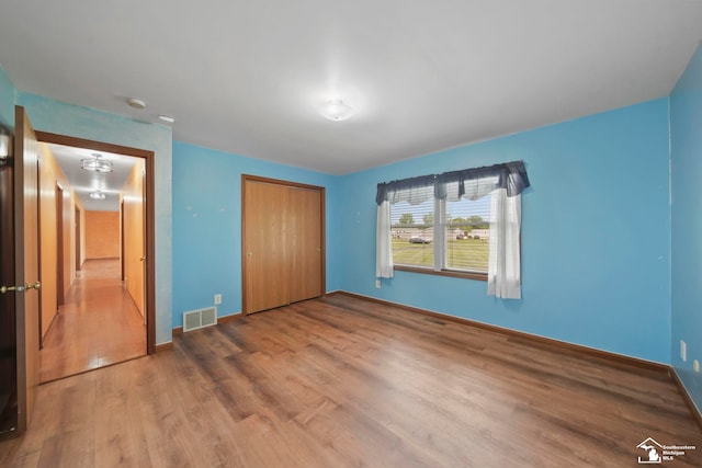 214 Roosevelt St, Dundee, MI 48131 - unfurnished bedroom with wood finished floors, a closet, and baseboards
