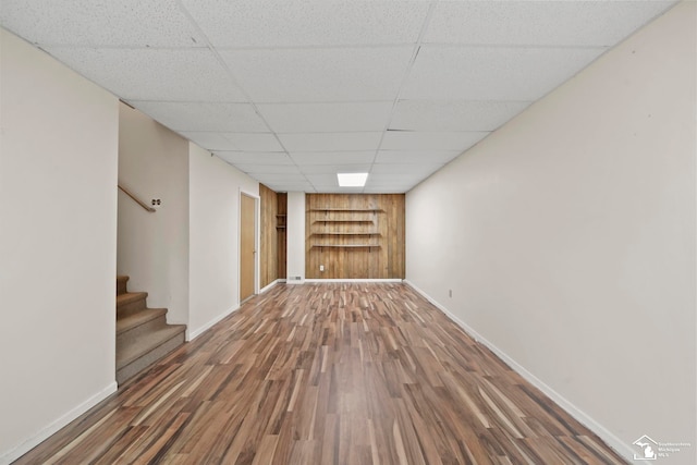 214 Roosevelt St, Dundee, MI 48131 - unfurnished room with built in features, wood finished floors, baseboards, a drop ceiling, and stairway