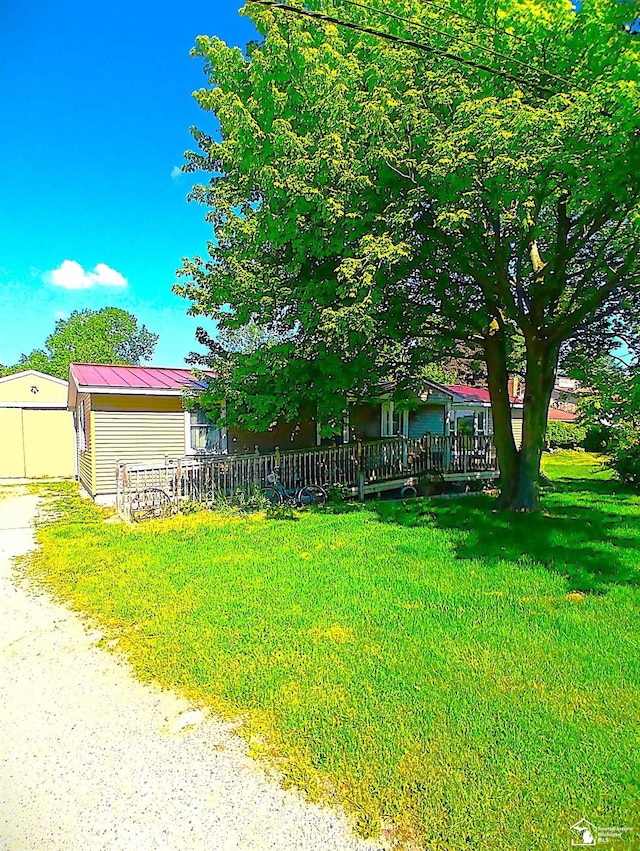 9361 Exeter Rd, Carleton, MI 48117 - view of green lawn featuring a wooden deck