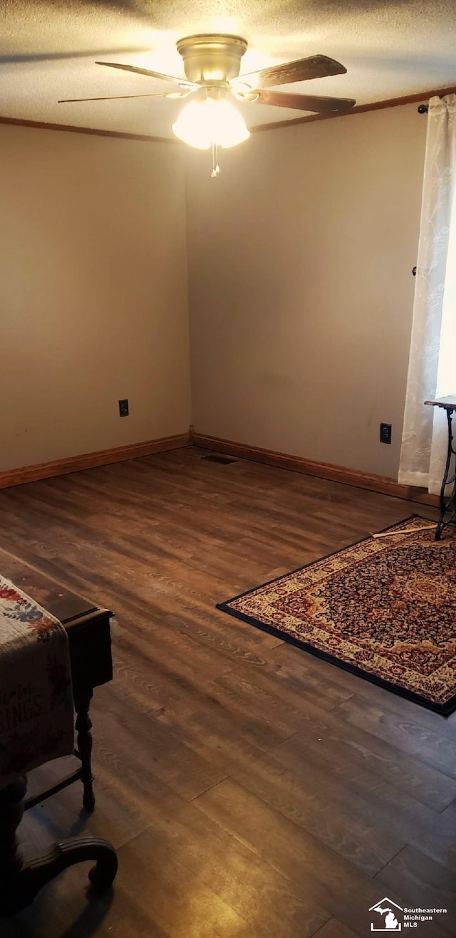 9361 Exeter Rd, Carleton, MI 48117 - spare room featuring ceiling fan, dark wood-style flooring, and baseboards