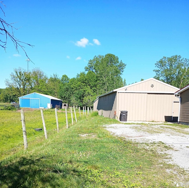9361 Exeter Rd, Carleton, MI 48117 - view of green lawn with a pole building, a detached garage, and an outbuilding