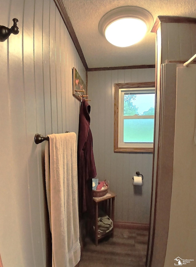 9361 Exeter Rd, Carleton, MI 48117 - bathroom featuring wood finished floors, ornamental molding, a textured ceiling, and wood walls