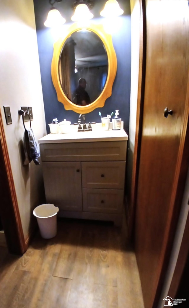 9361 Exeter Rd, Carleton, MI 48117 - bathroom featuring vanity, wood finished floors, and baseboards