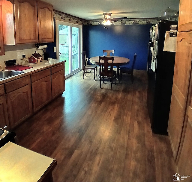 9361 Exeter Rd, Carleton, MI 48117 - kitchen with dark wood finished floors, a ceiling fan, freestanding refrigerator, a sink, and light countertops