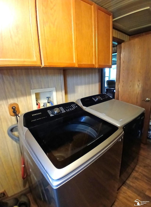9361 Exeter Rd, Carleton, MI 48117 - kitchen with washing machine and dryer, dark wood finished floors, wooden walls, and light countertops