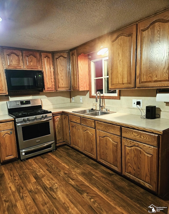 9361 Exeter Rd, Carleton, MI 48117 - kitchen featuring black microwave, gas stove, a sink, dark wood-type flooring, and light countertops