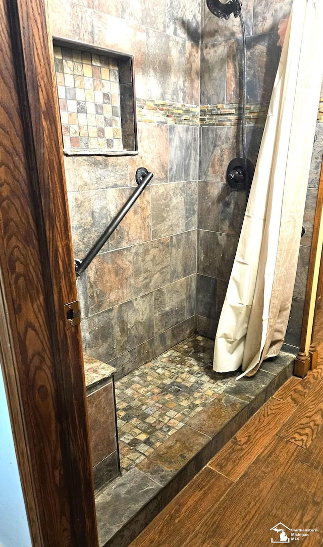9361 Exeter Rd, Carleton, MI 48117 - full bathroom with a tile shower and wood finished floors