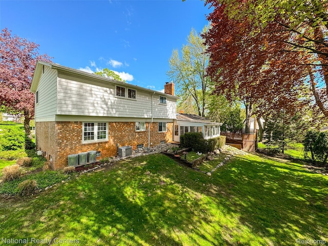 892 Hemlock Ct, Rochester, MI 48307 - rear view of property with a chimney, central AC, brick siding, and a lawn