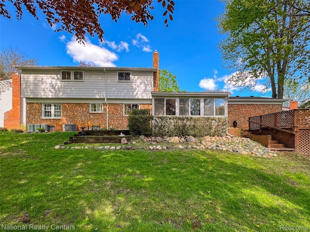 892 Hemlock Ct, Rochester, MI 48307 - back of house featuring a chimney, a yard, a sunroom, central air condition unit, and brick siding