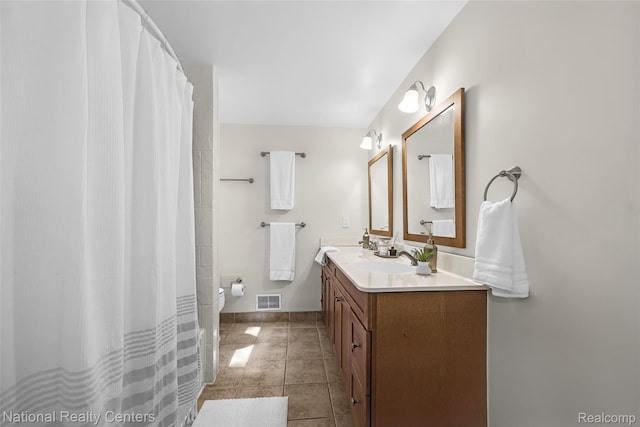 892 Hemlock Ct, Rochester, MI 48307 - bathroom with double vanity, baseboards, toilet, and tile patterned flooring