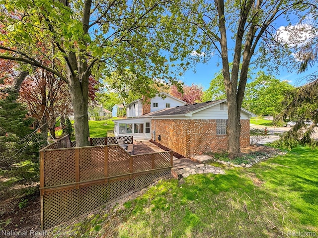 892 Hemlock Ct, Rochester, MI 48307 - rear view of property with brick siding, a yard, and a wooden deck