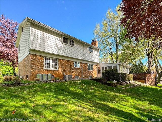 892 Hemlock Ct, Rochester, MI 48307 - rear view of property featuring a chimney, a sunroom, brick siding, and central AC