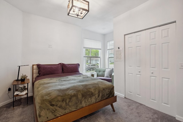 1645 College Ave SE, Grand Rapids, MI 49507 - carpeted bedroom with baseboards, a chandelier, and a closet