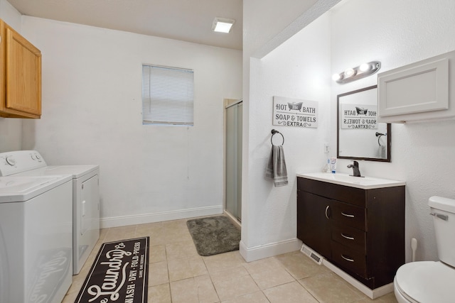 1645 College Ave SE, Grand Rapids, MI 49507 - bathroom with separate washer and dryer, toilet, vanity, a shower stall, and tile patterned flooring