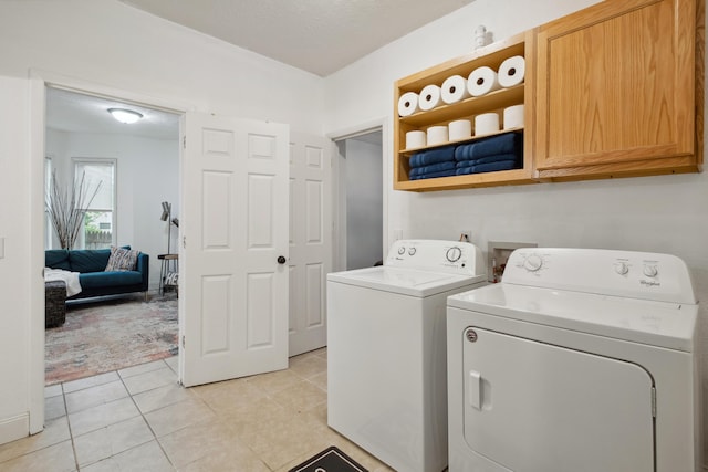 1645 College Ave SE, Grand Rapids, MI 49507 - laundry room featuring cabinet space, independent washer and dryer, and light tile patterned flooring