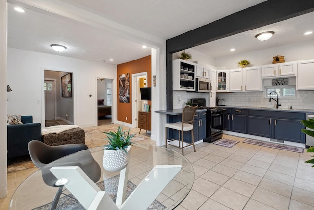 1645 College Ave SE, Grand Rapids, MI 49507 - dining room featuring recessed lighting, light tile patterned floors, and baseboards
