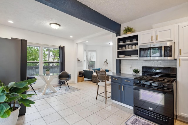 1645 College Ave SE, Grand Rapids, MI 49507 - kitchen with stainless steel microwave, black gas range oven, a textured ceiling, open shelves, and light tile patterned floors