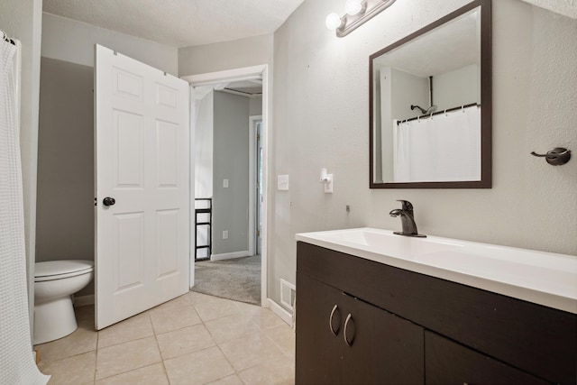 1645 College Ave SE, Grand Rapids, MI 49507 - bathroom with vanity, toilet, and tile patterned flooring