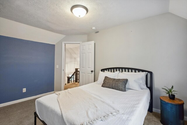 1645 College Ave SE, Grand Rapids, MI 49507 - bedroom featuring vaulted ceiling, carpet floors, baseboards, and a textured ceiling