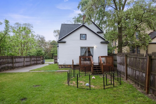 1645 College Ave SE, Grand Rapids, MI 49507 - back of property featuring a wooden deck, a shingled roof, and a chimney
